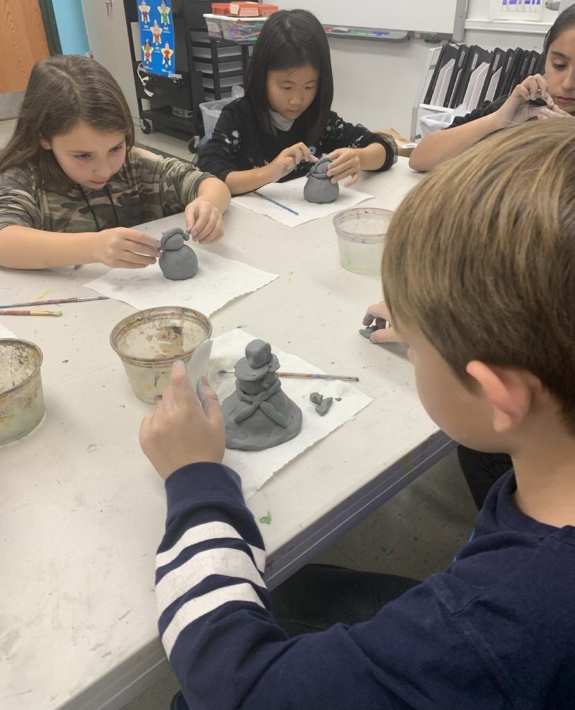 Young artists creating clay sculptures and art at our family-friendly studio in Englewood, NJ